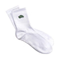White socks with a green logo on a wooden surface