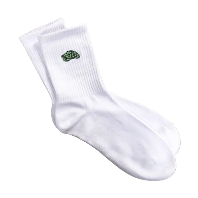 White socks with a green logo on a wooden surface